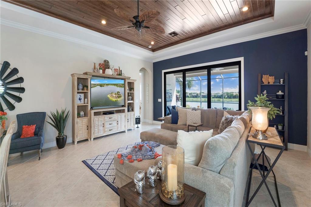 1410 Redona Way Naples, FL 34113 - Photo 8 of 50 a living room with furniture and a flat screen tv