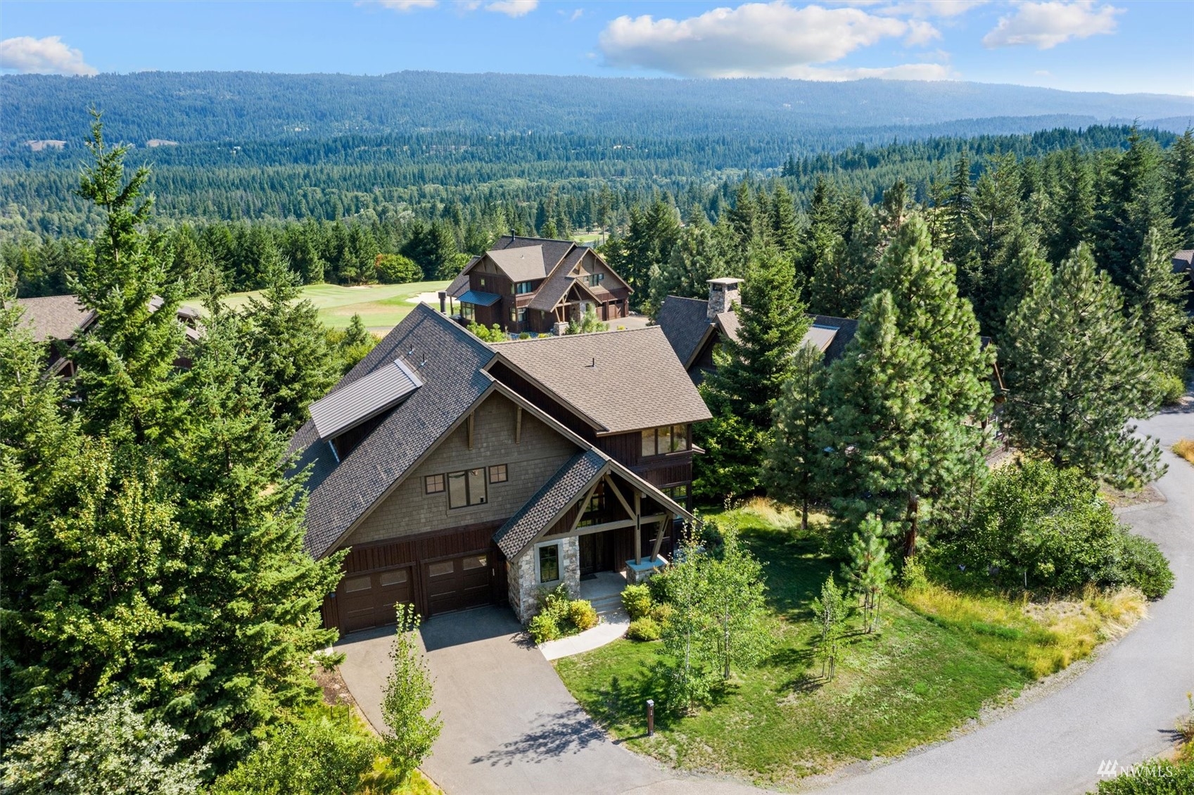 an aerial view of a house with a yard and lake view