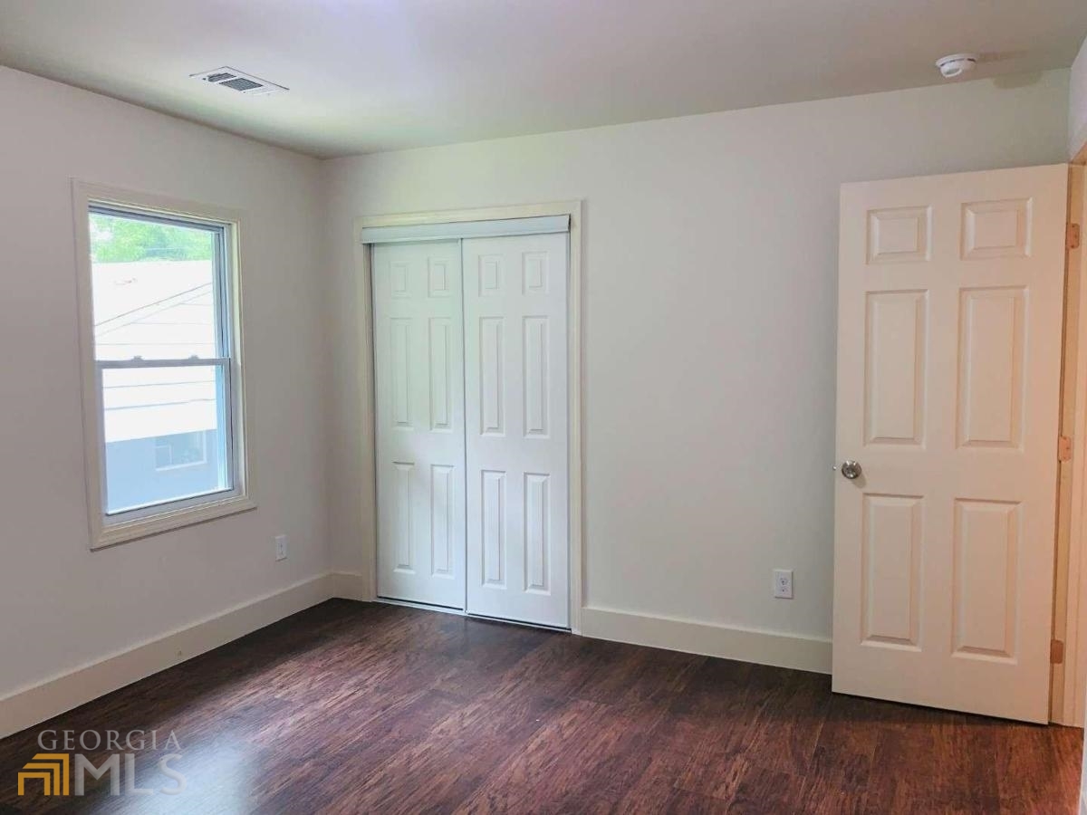 364 Brooks Avenue Southwest Atlanta, GA 30310 - Photo 21 of 21 an empty room with wooden floor and window
