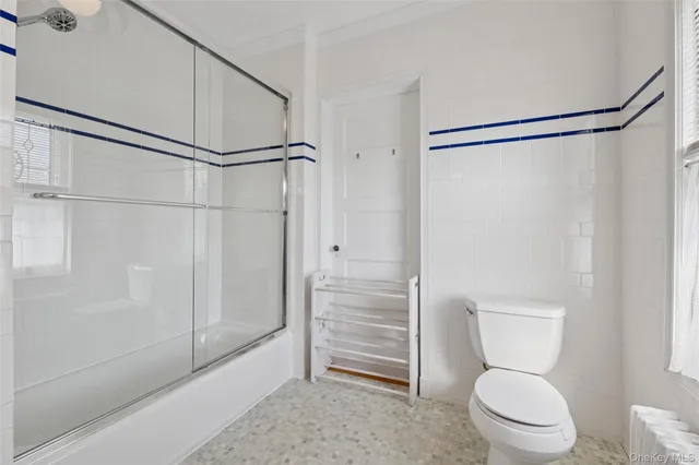 a bathroom with a toilet and a shower