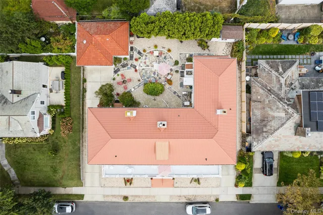 an aerial view of a house with a yard and large trees