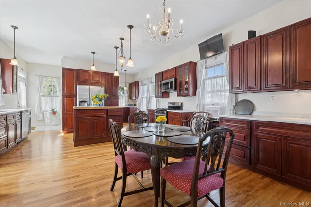a view of a dining room with furniture a chandelier and wooden floor