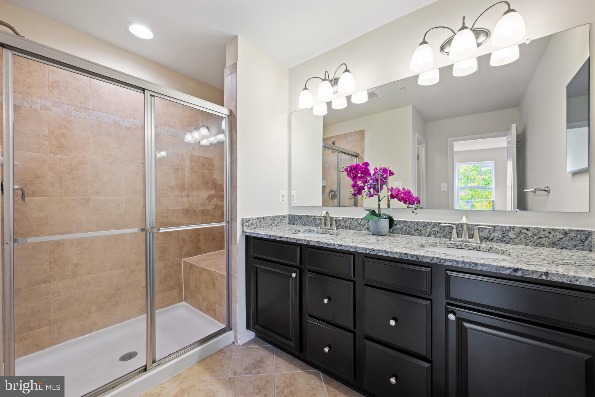 7062 Foxton Way Hanover, MD 21076 - Photo 25 of 41 a bathroom with a granite countertop sink a large mirror and shower
