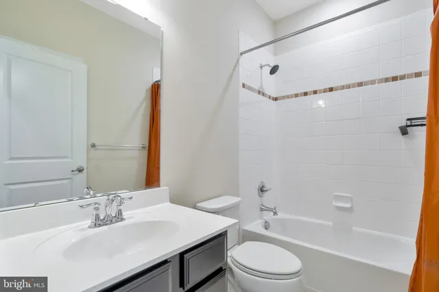 a bathroom with a sink vanity mirror and toilet