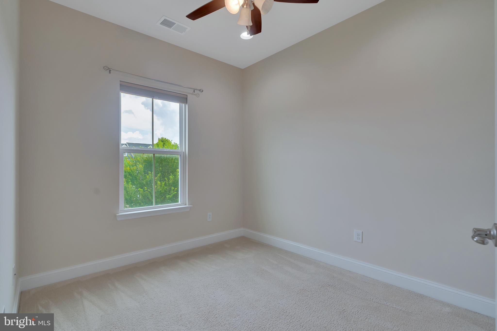 102 Patriots Path Malvern, PA 19355 - Photo 28 of 30 an empty room with ceiling fan and window