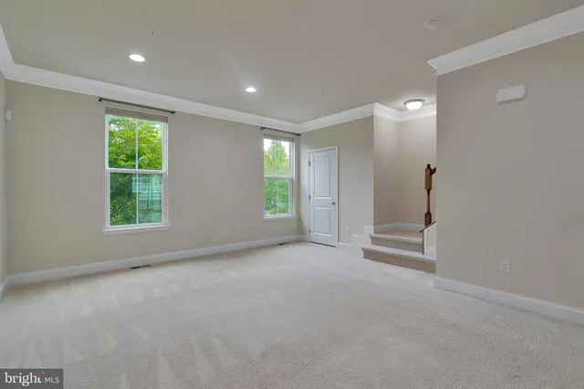 an empty room with windows and closet