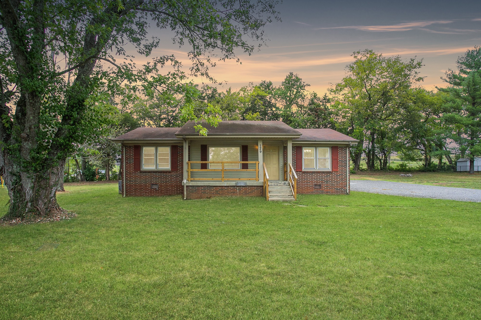 a front view of a house with a garden
