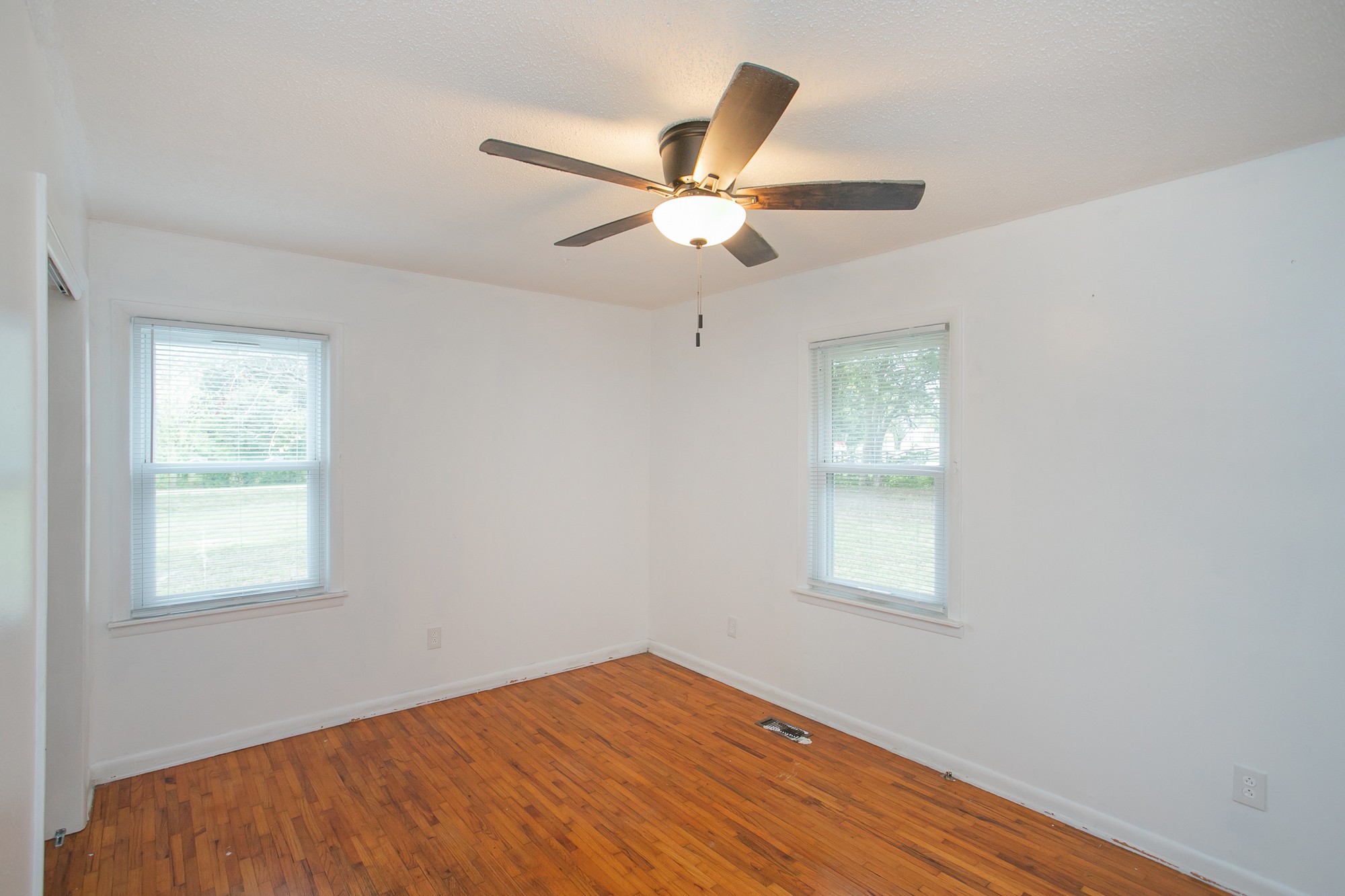 129 Poplar Street Eagleville, TN 37060 - Photo 14 of 23 a view of empty room with wooden floor and fan