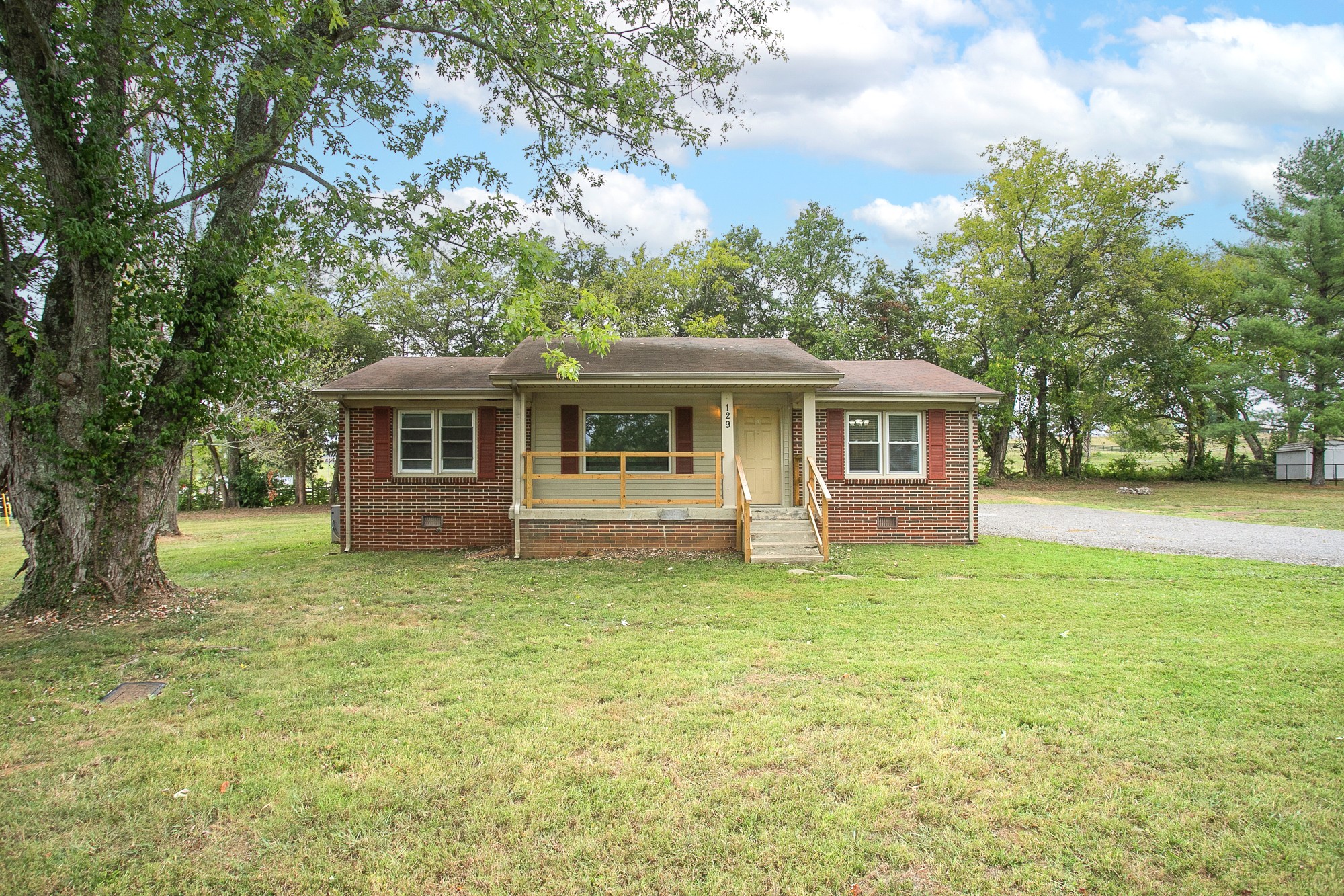 129 Poplar Street Eagleville, TN 37060 - Photo 2 of 23 a front view of a house with a garden