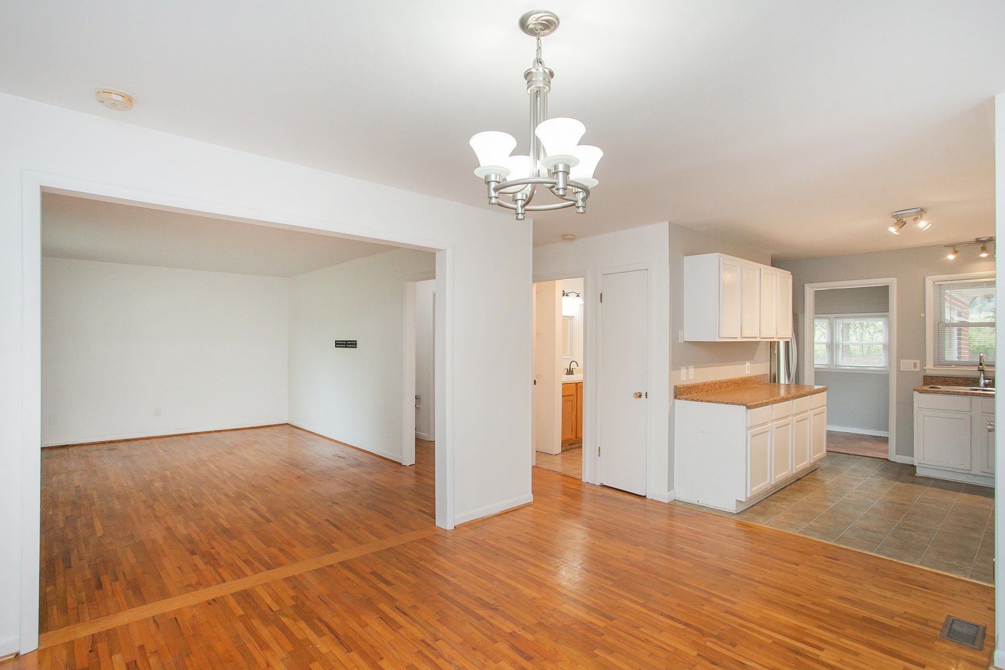 129 Poplar Street Eagleville, TN 37060 - Photo 4 of 23 a view of a kitchen with wooden floor and a chandelier