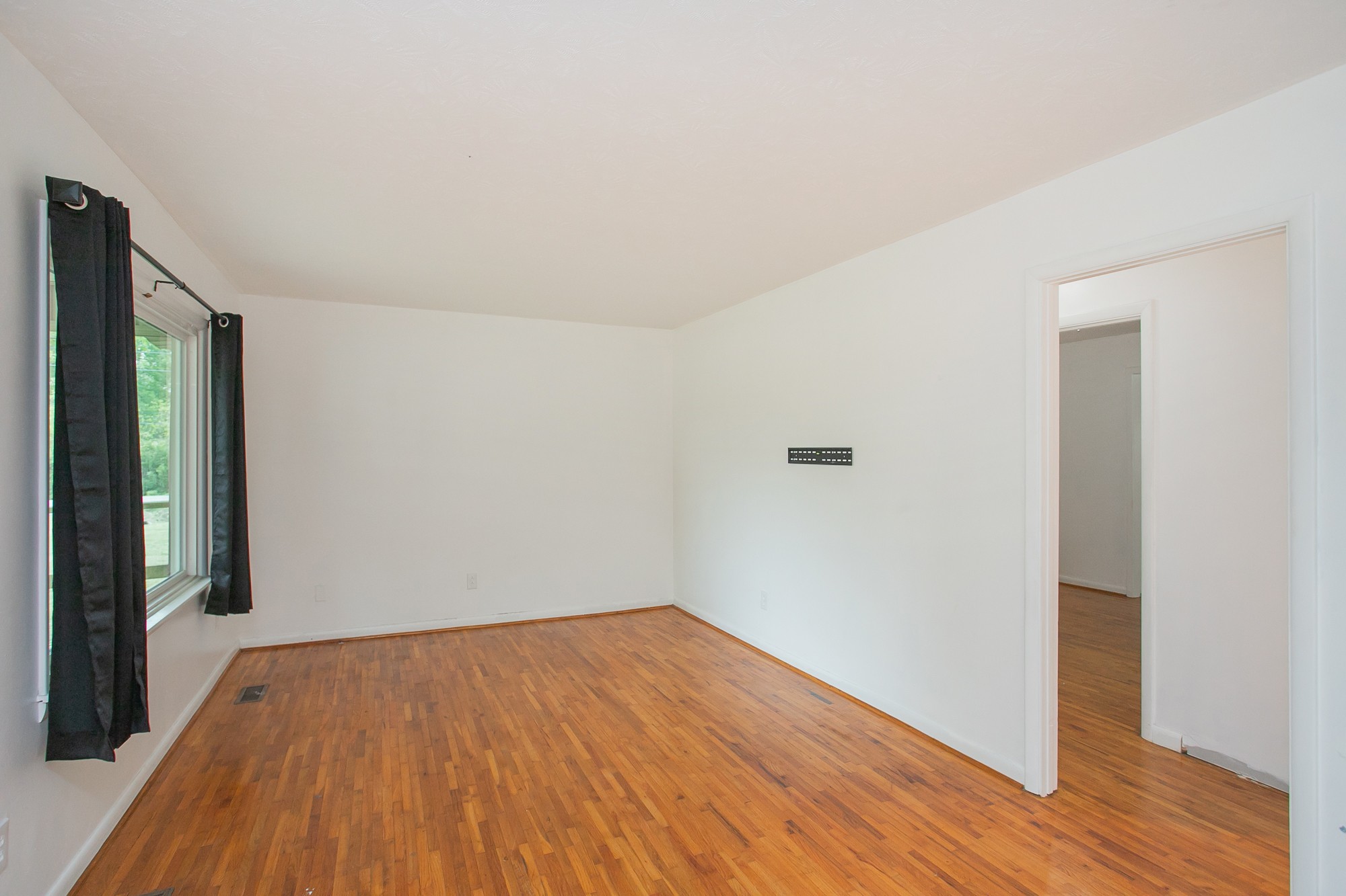 129 Poplar Street Eagleville, TN 37060 - Photo 5 of 23 a view of empty room with wooden floor and fan