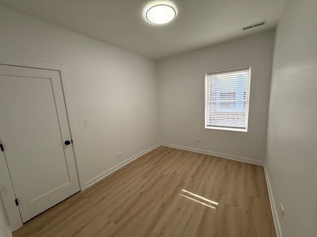 7717 North Sheridan Road, Unit 3R Chicago, IL 60626 - Photo 11 of 17 an empty room with wooden floor and windows