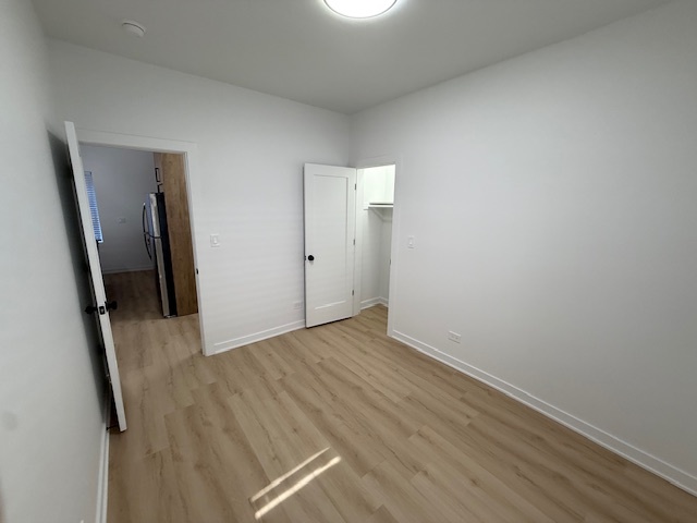 7717 North Sheridan Road, Unit 3R Chicago, IL 60626 - Photo 12 of 17 wooden floor in an empty room