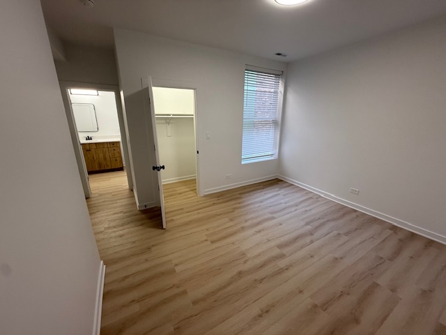 7717 North Sheridan Road, Unit 3R Chicago, IL 60626 - Photo 13 of 17 wooden floor in an empty room with a window