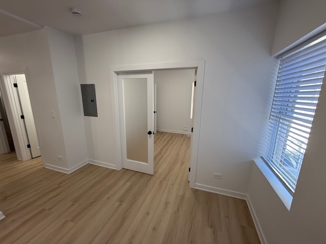 7717 North Sheridan Road, Unit 3R Chicago, IL 60626 - Photo 6 of 17 an empty room with wooden floor and windows