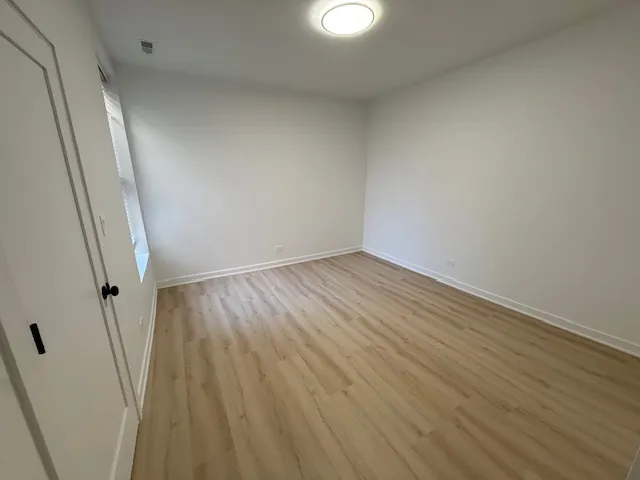 wooden floor in a hall with an empty room