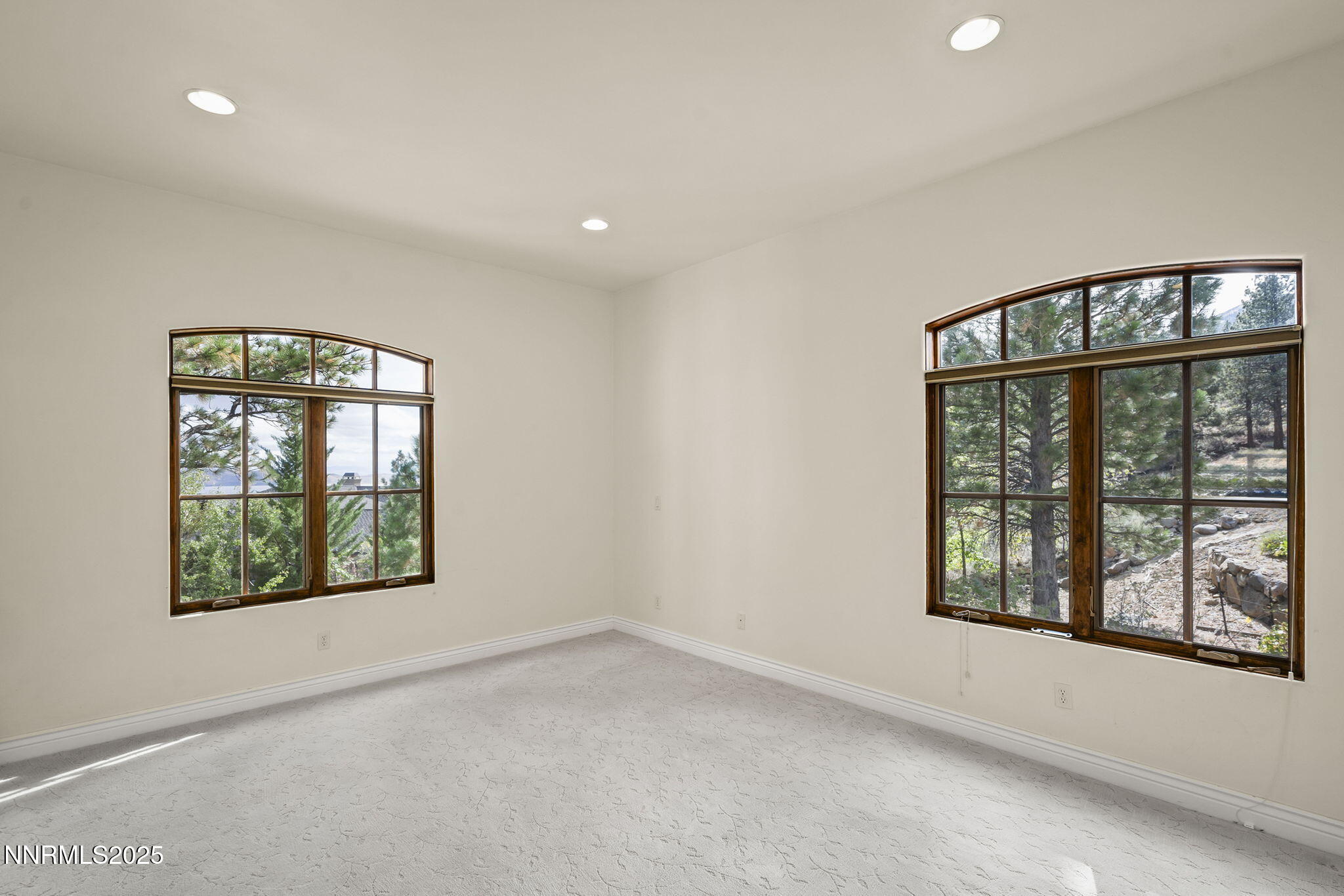 4810 West Pinewild Road Reno, NV 89511 - Photo 20 of 42 an empty room with wooden floor and windows