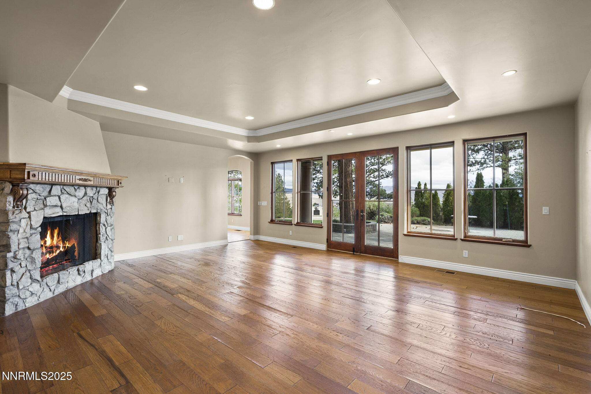 4810 West Pinewild Road Reno, NV 89511 - Photo 22 of 42 a view of an empty room with wooden floor fireplace and a window