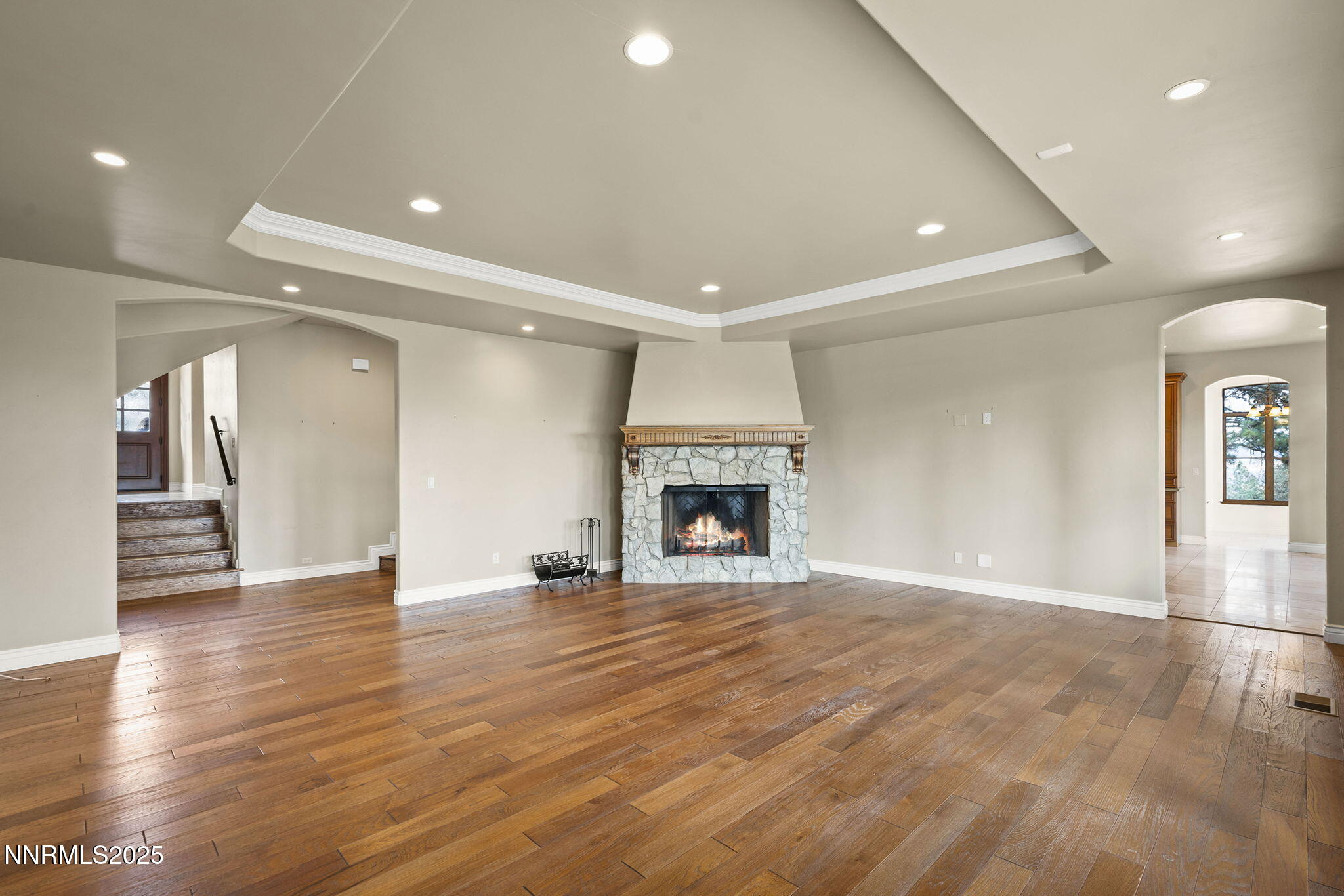 4810 West Pinewild Road Reno, NV 89511 - Photo 23 of 42 a view of an empty room with wooden floor fireplace and a window
