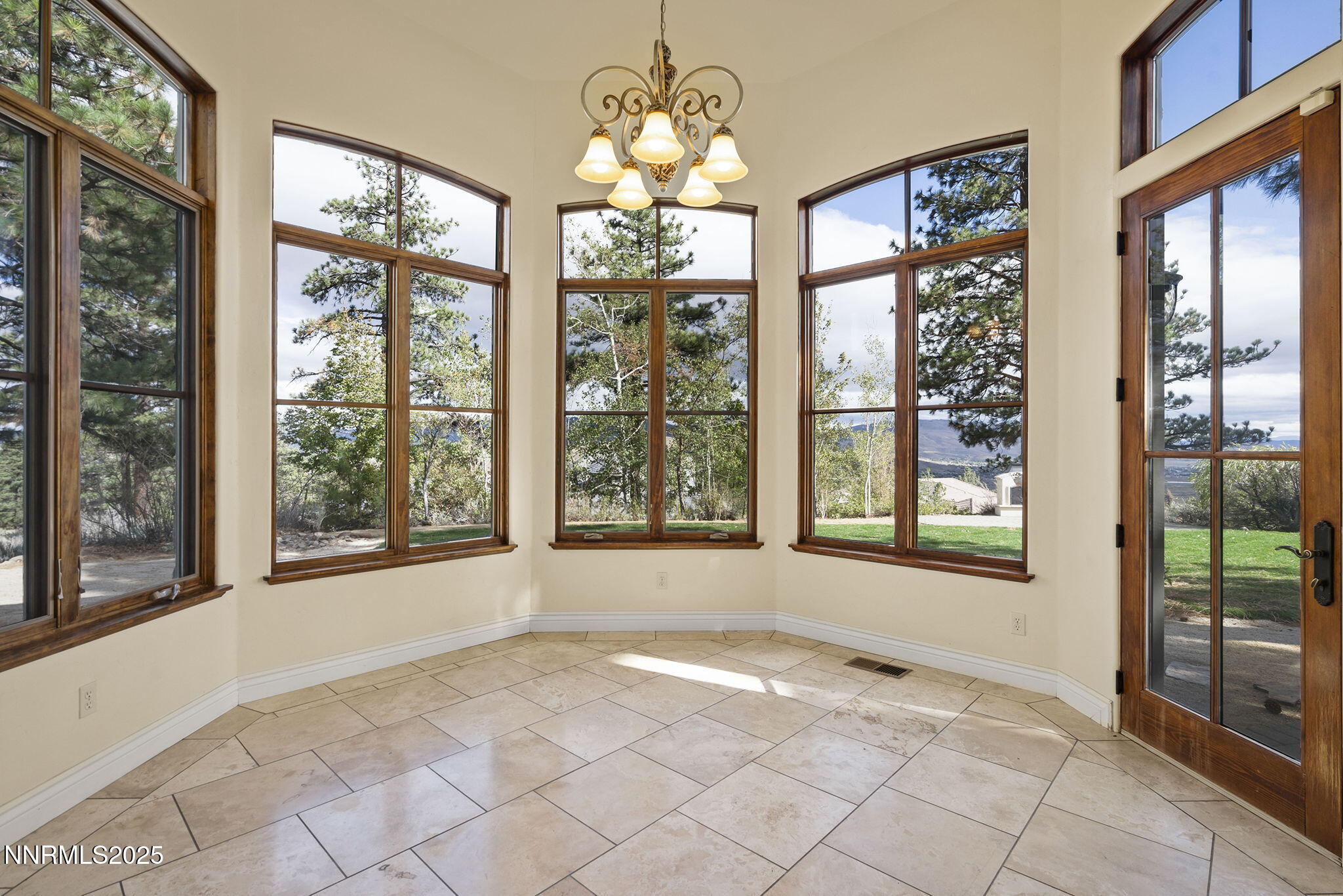 4810 West Pinewild Road Reno, NV 89511 - Photo 28 of 42 a view of an empty room with a window and chandelier