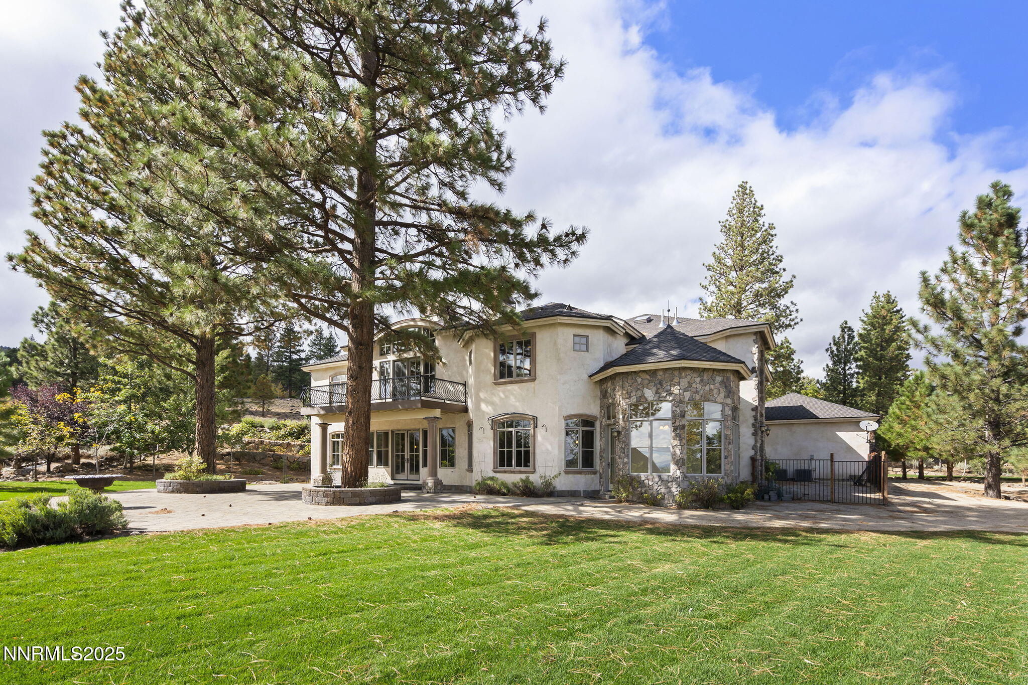 4810 West Pinewild Road Reno, NV 89511 - Photo 38 of 42 a front view of a house with a garden and trees