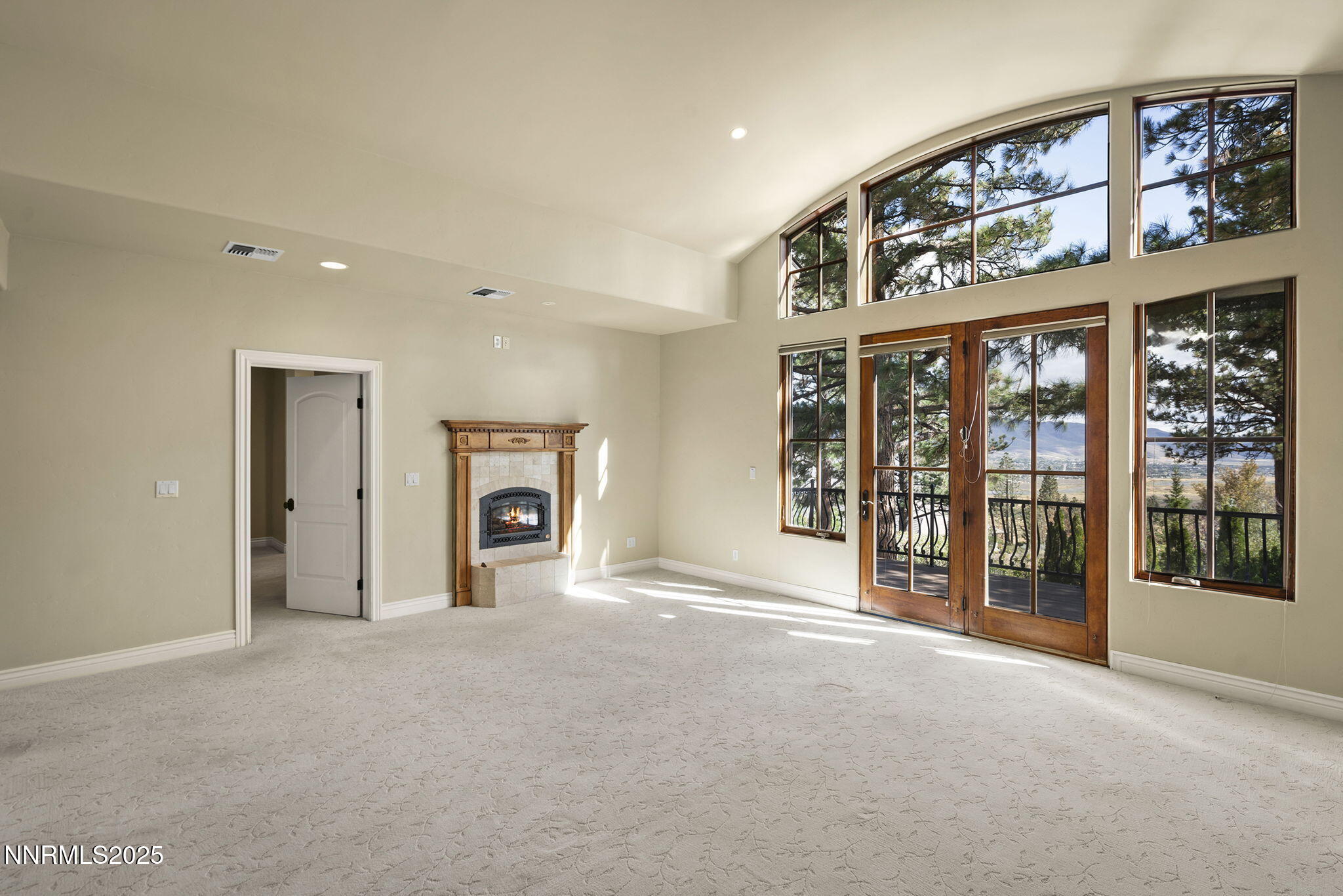 4810 West Pinewild Road Reno, NV 89511 - Photo 9 of 42 a view of an empty room with a fireplace and a large window