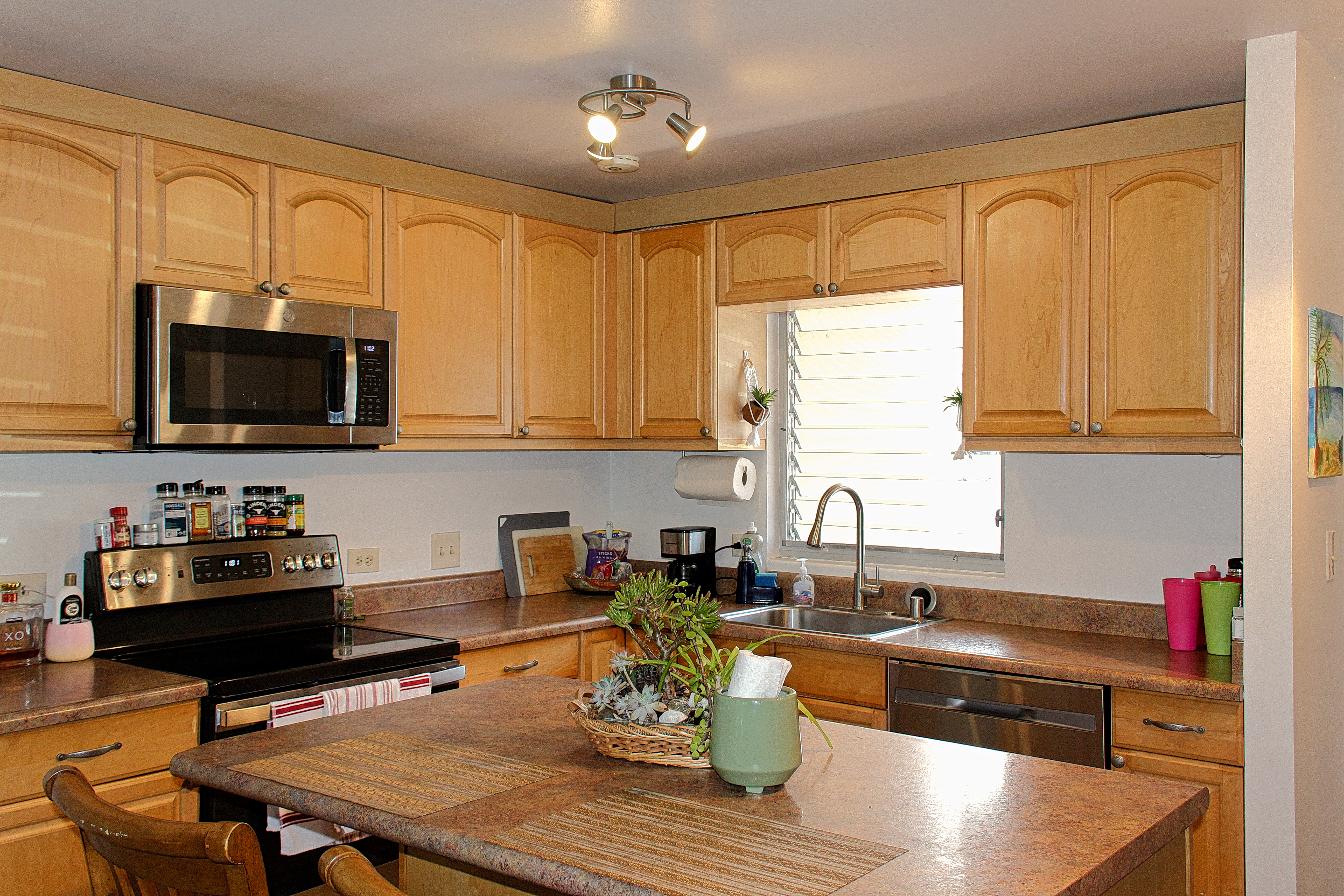 a kitchen with a microwave a stove and cabinets