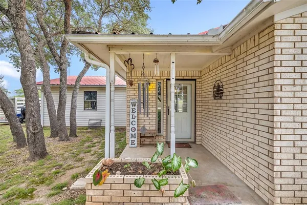 a backyard of a house with table and chairs