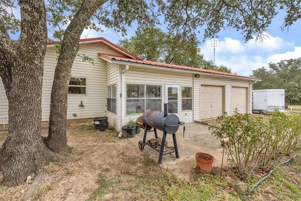 a view of house with outdoor space and swimming pool