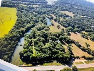 16824 Wortham Bend Road China Spring, TX 76633 - Photo 8 of 16 a view of a yard with a tree
