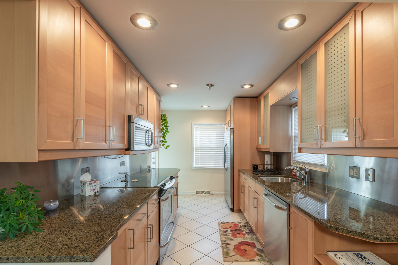 743 Spring Road Elmhurst, IL 60126 - Photo 7 of 21 a kitchen with kitchen island granite countertop a sink a counter top space and cabinets