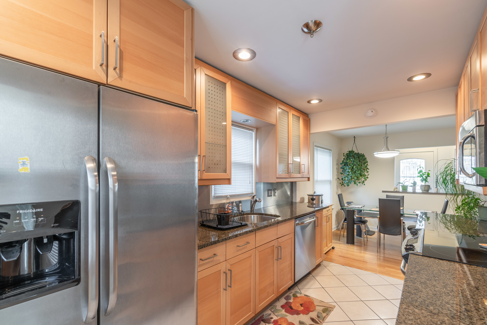 743 Spring Road Elmhurst, IL 60126 - Photo 8 of 21 a large kitchen with stainless steel appliances kitchen island granite countertop a refrigerator and a sink