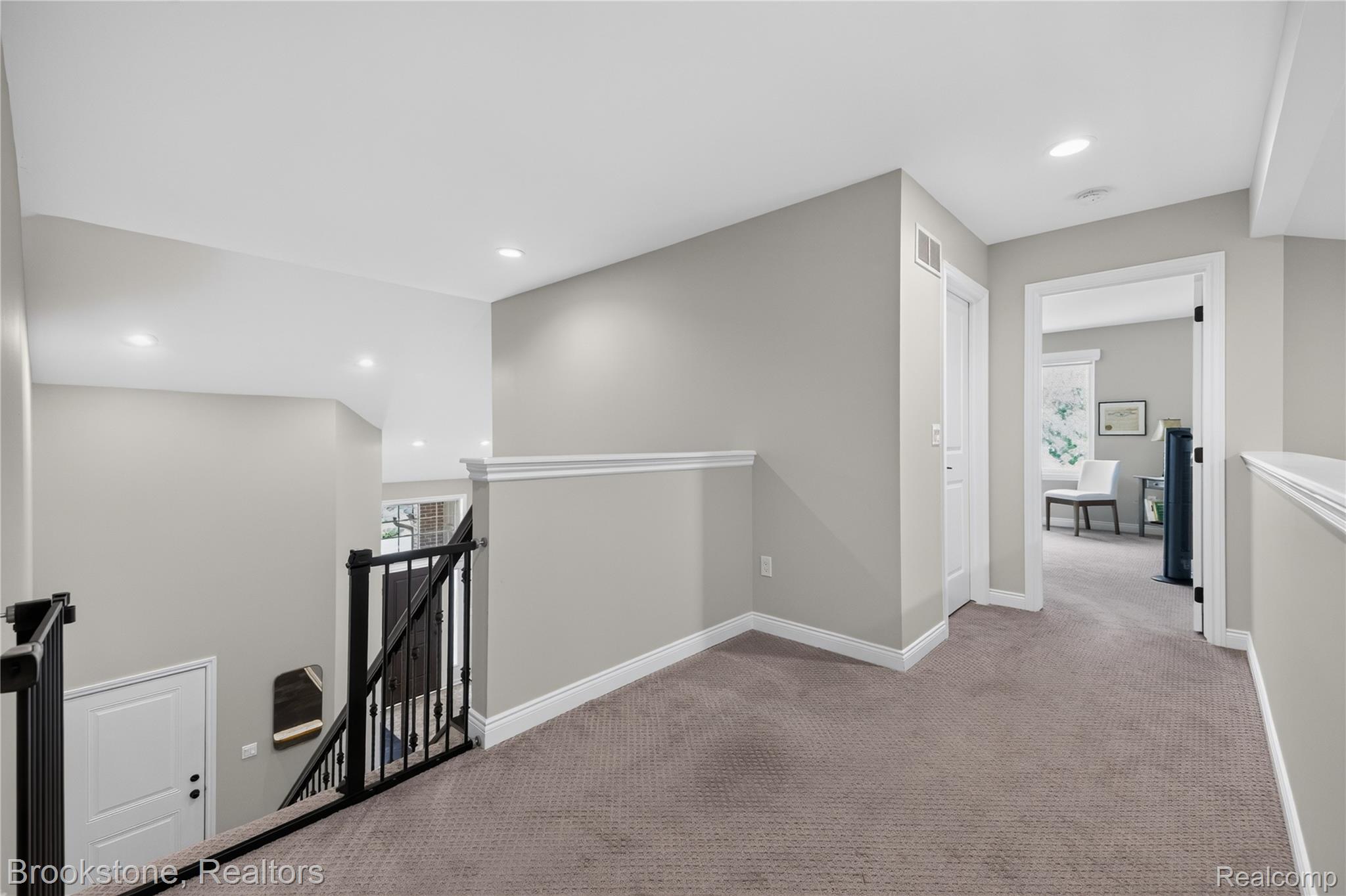 2167 Sanctuary Court Rochester, MI 48309 - Photo 54 of 68 Carpeted landing with white baseboards and chair rail molding