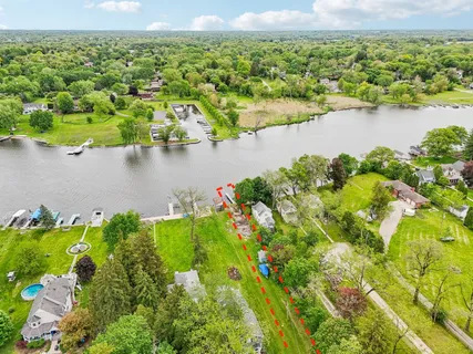 an aerial view of a houses with a lake view