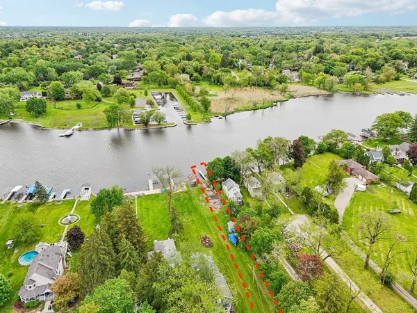 an aerial view of a houses with a lake view