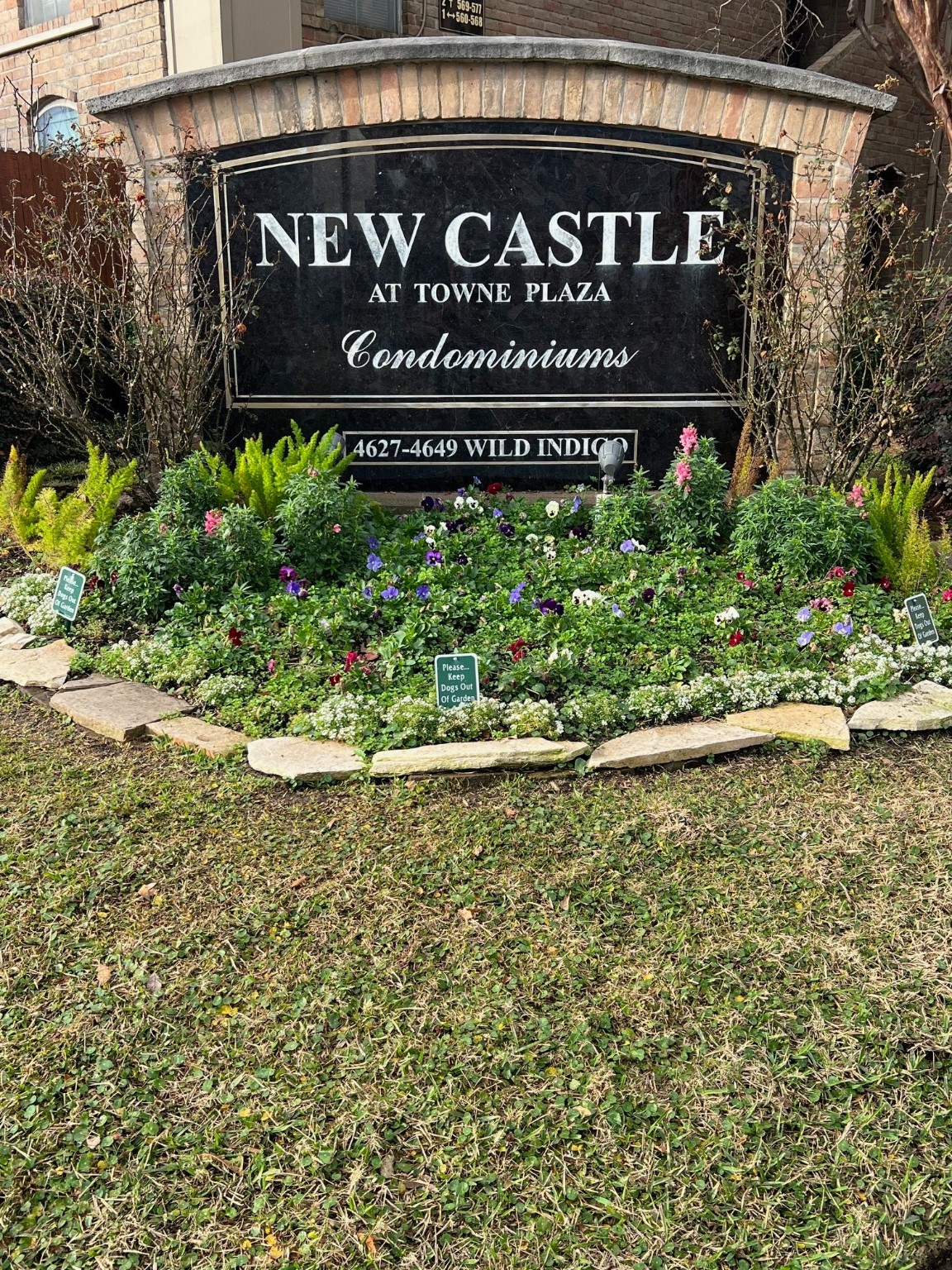 a sign broad in front of flowers