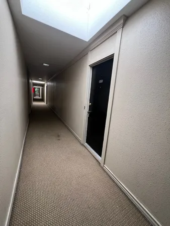 a view of empty room with wooden floor and fireplace