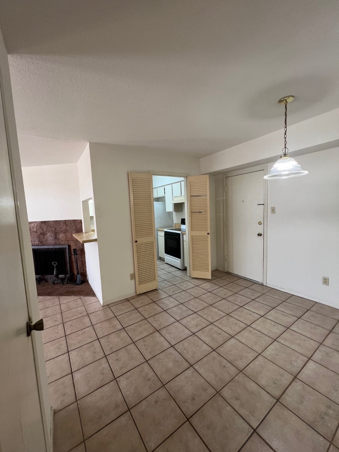 4631 Wild Indigo Street, Unit 572 Houston, TX 77027 - Photo 5 of 13 a view of empty room with wooden floor and fireplace