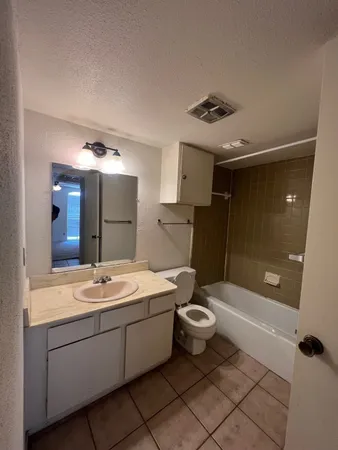 a bathroom with a sink a toilet and bathtub