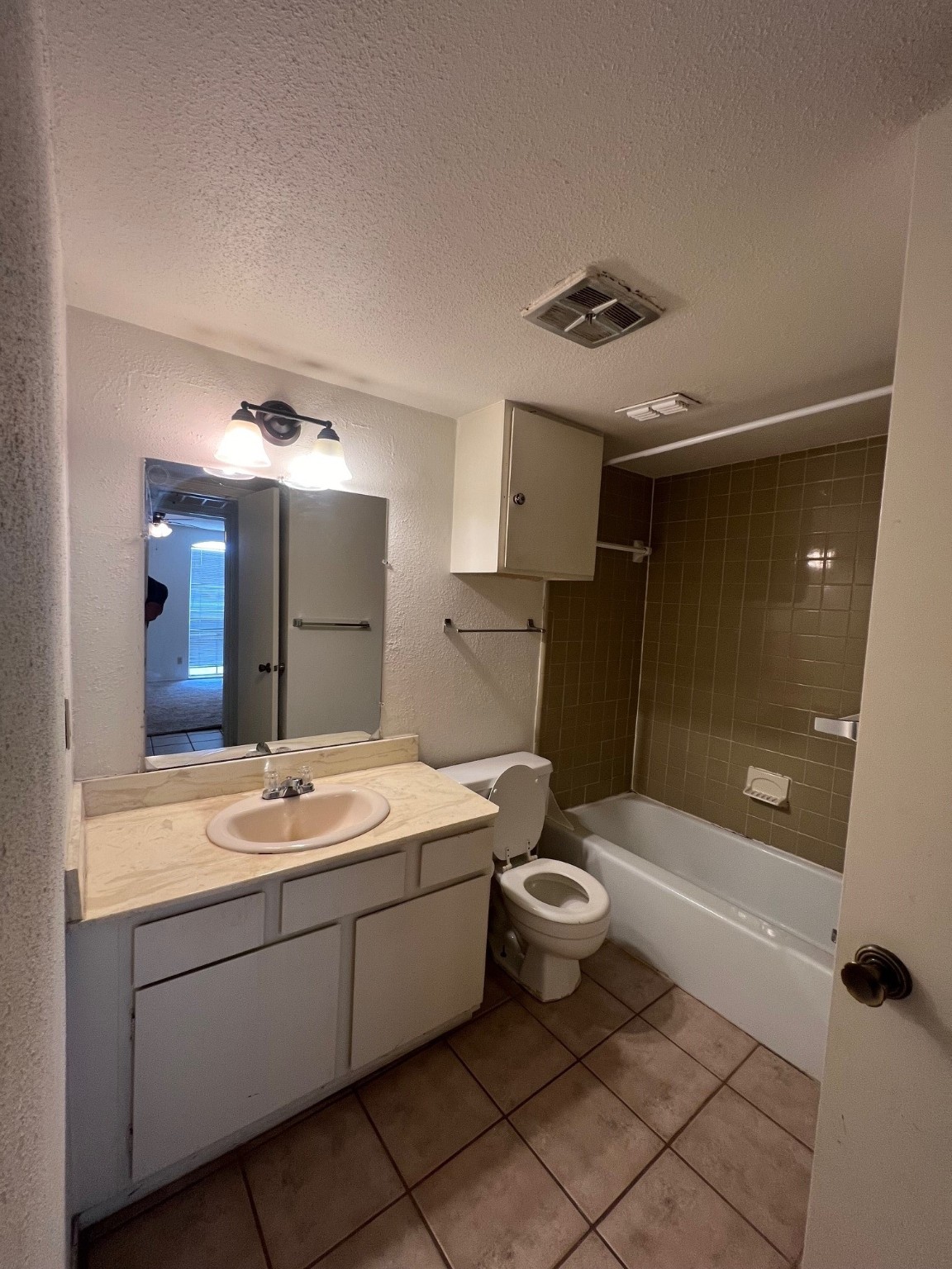 4631 Wild Indigo Street, Unit 572 Houston, TX 77027 - Photo 10 of 13 a bathroom with a sink a toilet and shower