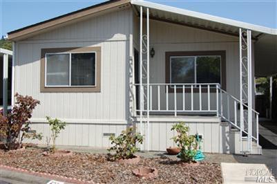 255 Hermosa Circle, Unit 255 Santa Rosa, CA 95409 - Photo 1 of 1 Double wide mobile home with rose garden in the front of the home.
