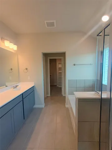 a large bathroom with a sink and mirror