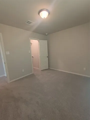 an empty room with a empty space and windows