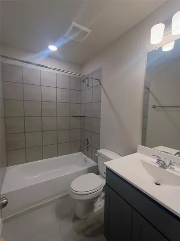 a bathroom with a bathtub a sink a toilet and a mirror