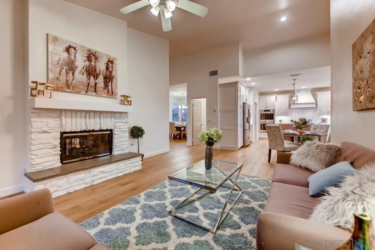 15825 Bent Tree Road Poway, CA 92064 - Photo 18 of 38 a living room with furniture a table and a fireplace