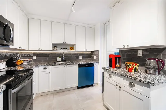 a kitchen with stainless steel appliances granite countertop a stove and a sink