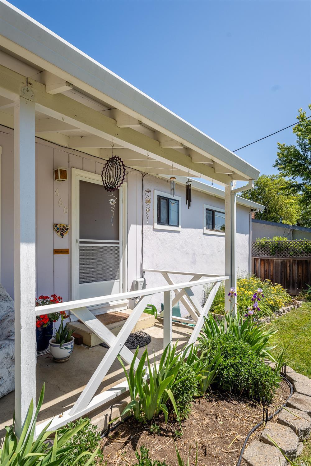 a front view of a house with a garden