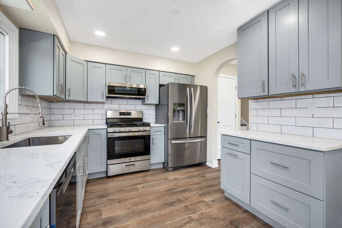 -n148 Silverleaf Boulevard Wheaton, IL 60187 - Photo 11 of 25 a kitchen with granite countertop a refrigerator stove and sink