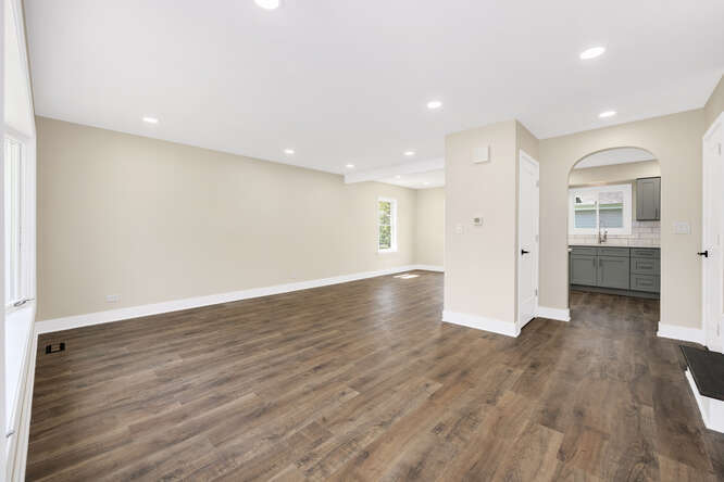 -n148 Silverleaf Boulevard Wheaton, IL 60187 - Photo 4 of 25 a view of an empty room with wooden floor and a kitchen