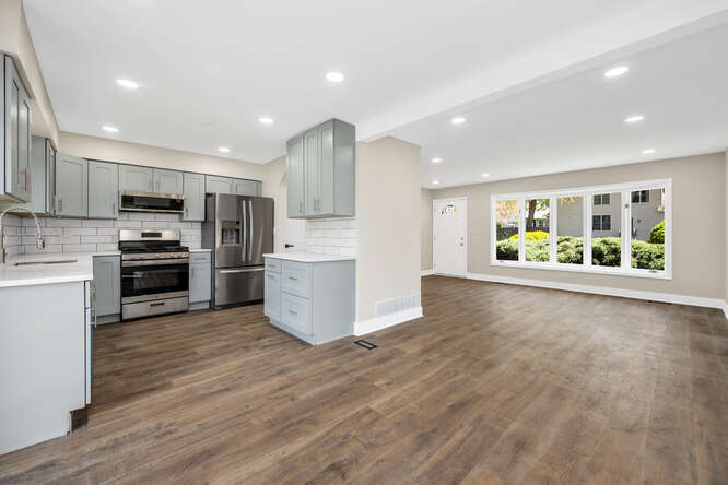 -n148 Silverleaf Boulevard Wheaton, IL 60187 - Photo 8 of 25 a open kitchen with stainless steel appliances kitchen island a large counter top and wooden floors